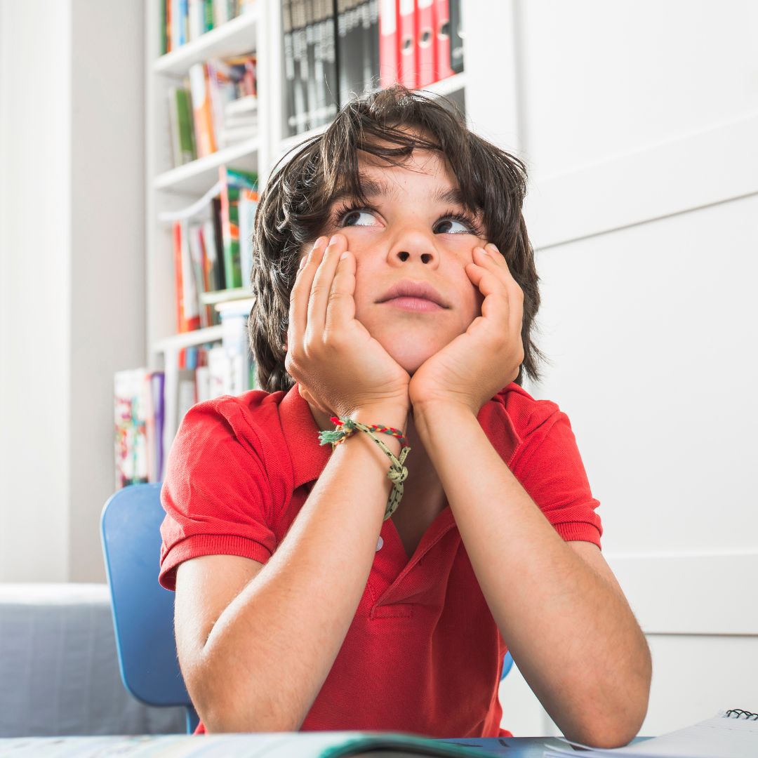 A kid thinking while doing homework.