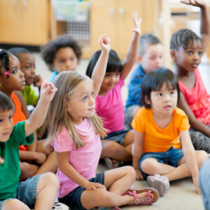 children raising their hands