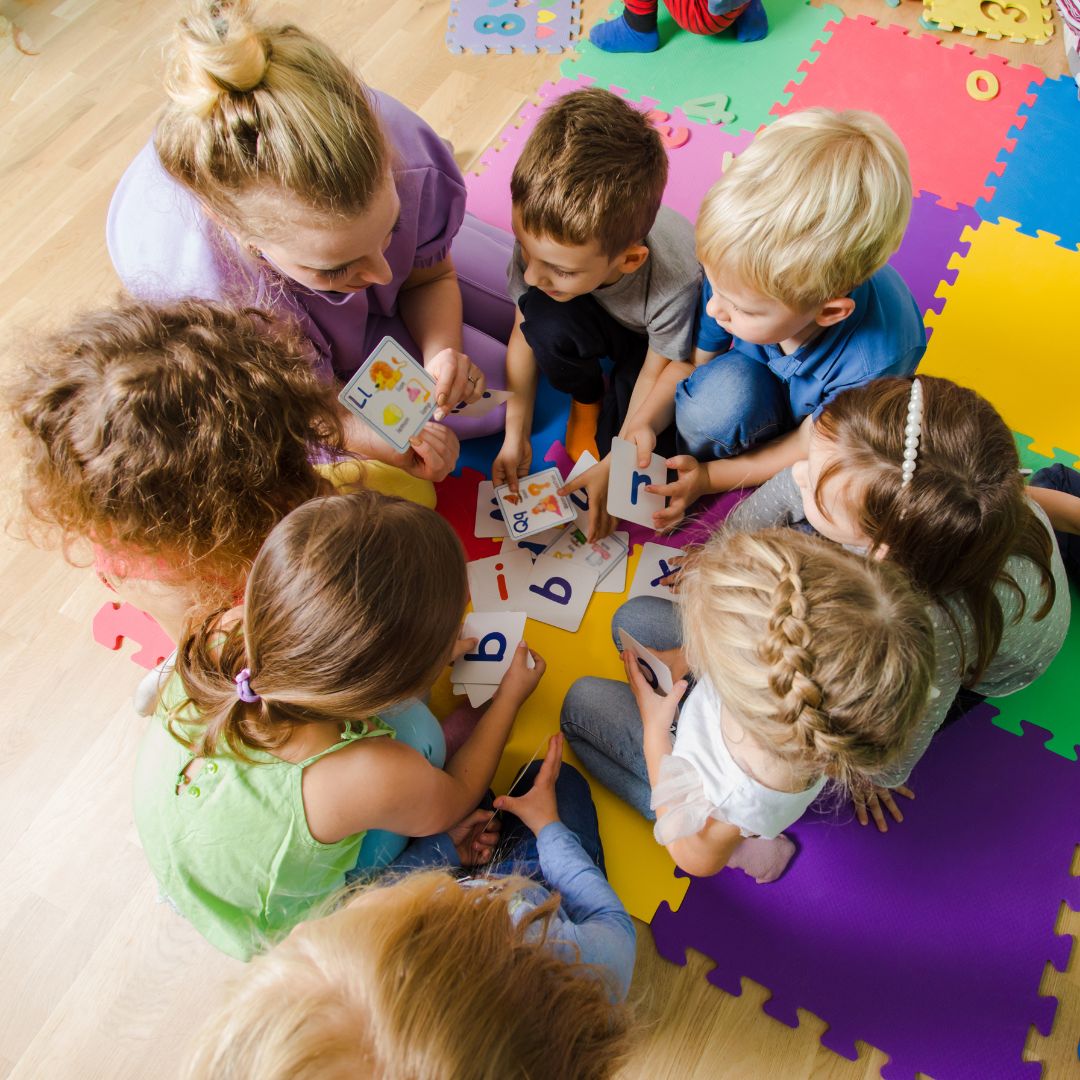 little kids listening to a teacher at daycare