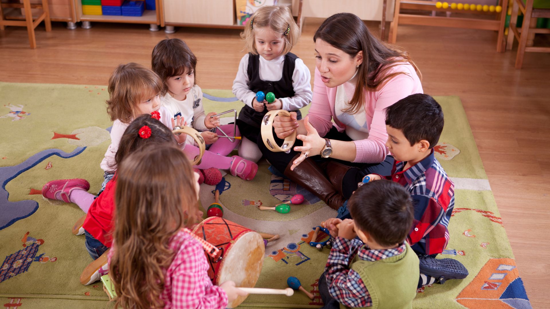 a teacher with her students in a circle