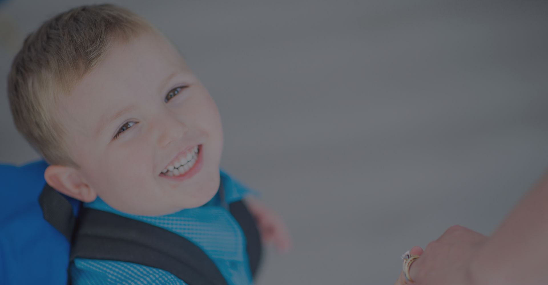 Young boy smiles walking into school