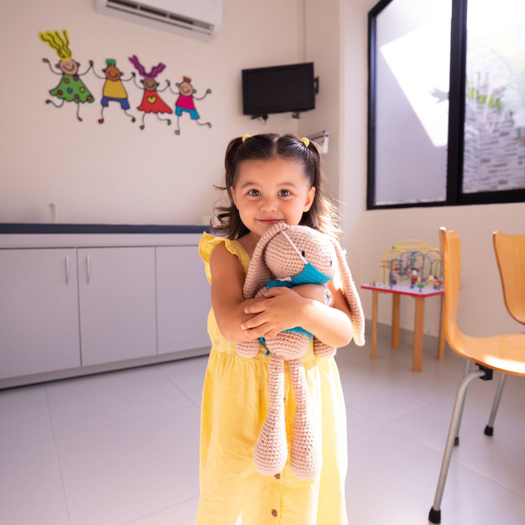 toddler holding stuffed animal