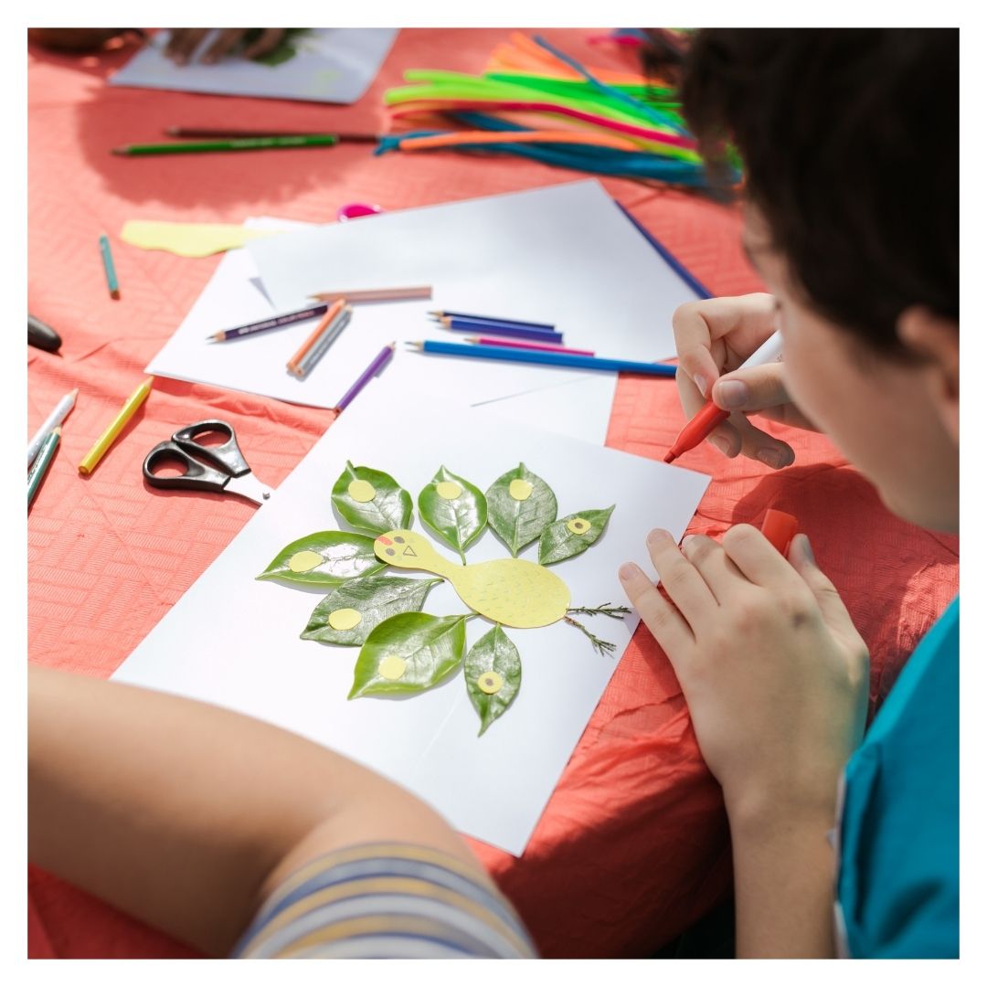 school-aged student working on art in an after school program