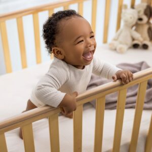 A young infant in a crib.