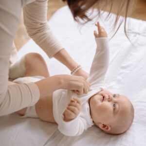 Mother Dressing Baby.